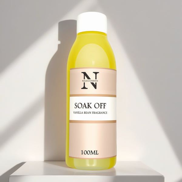 Gul flaska med vit kork innehållande soak off vätska för borttagning av gel naglar.